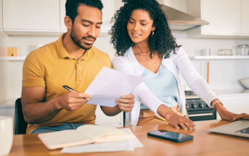 Couple reviewing mortgage questions at a kitchen table