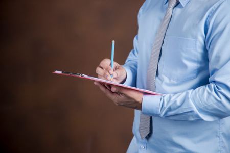 Man writing on a clipboard